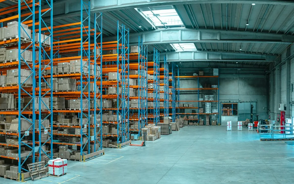 Cardboard boxes stored on tall shelving in a warehouse.